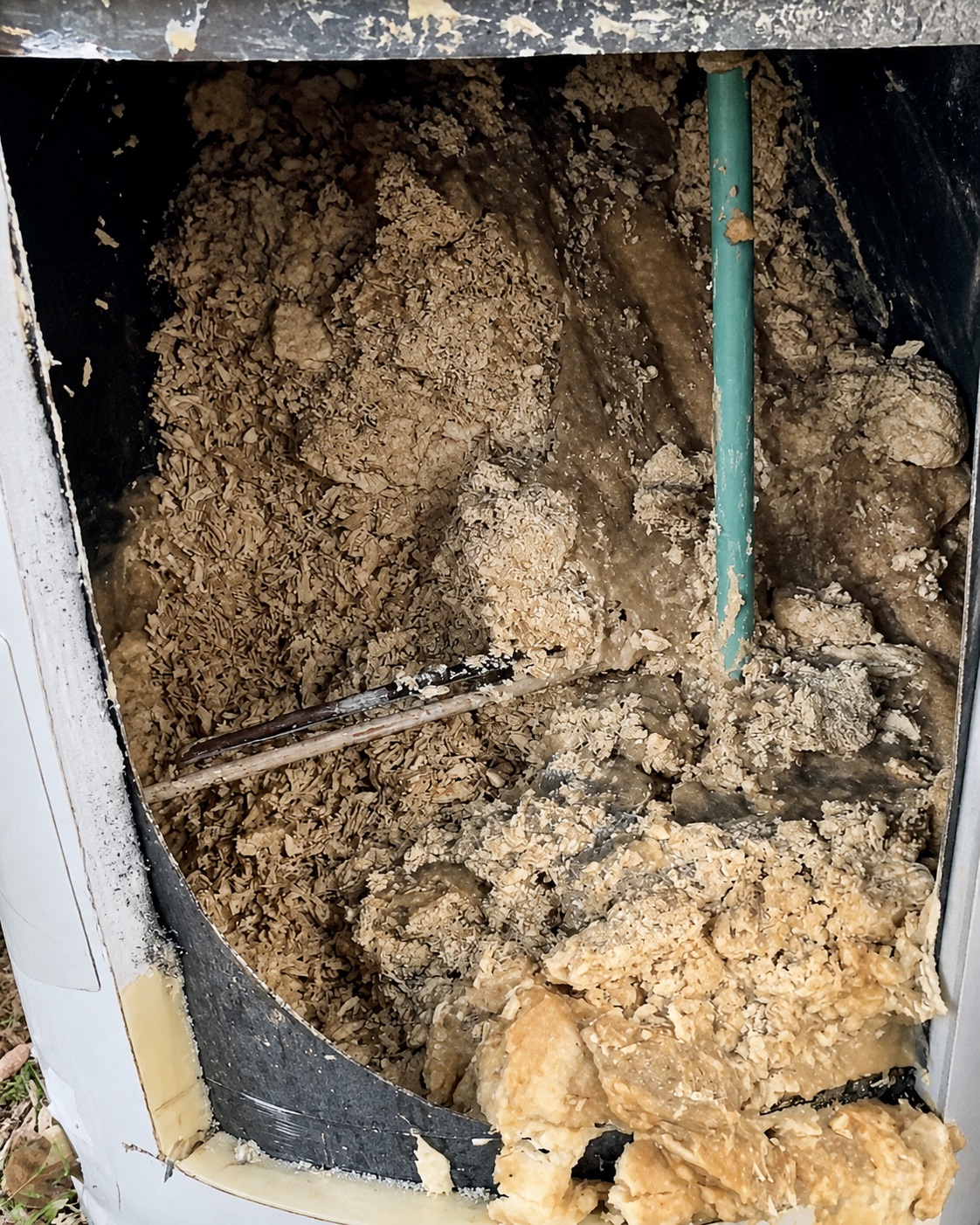 Cut-open residential water heater filled with heavy mineral and sediment buildup